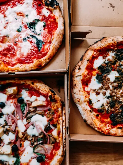 three pizzas in the box's ready to be delivered