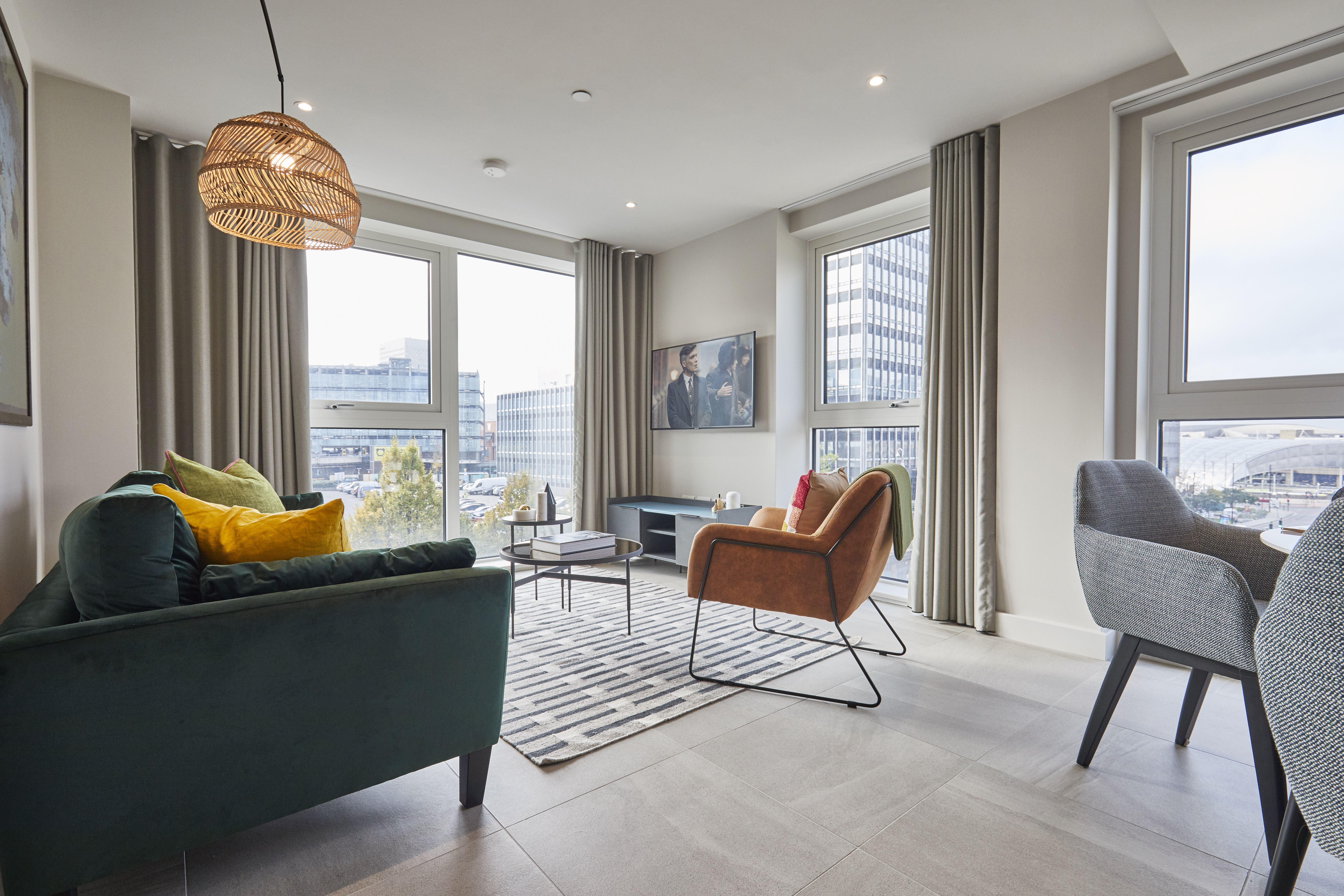 Lounge chair, two seater sofa, dining table and balcony views