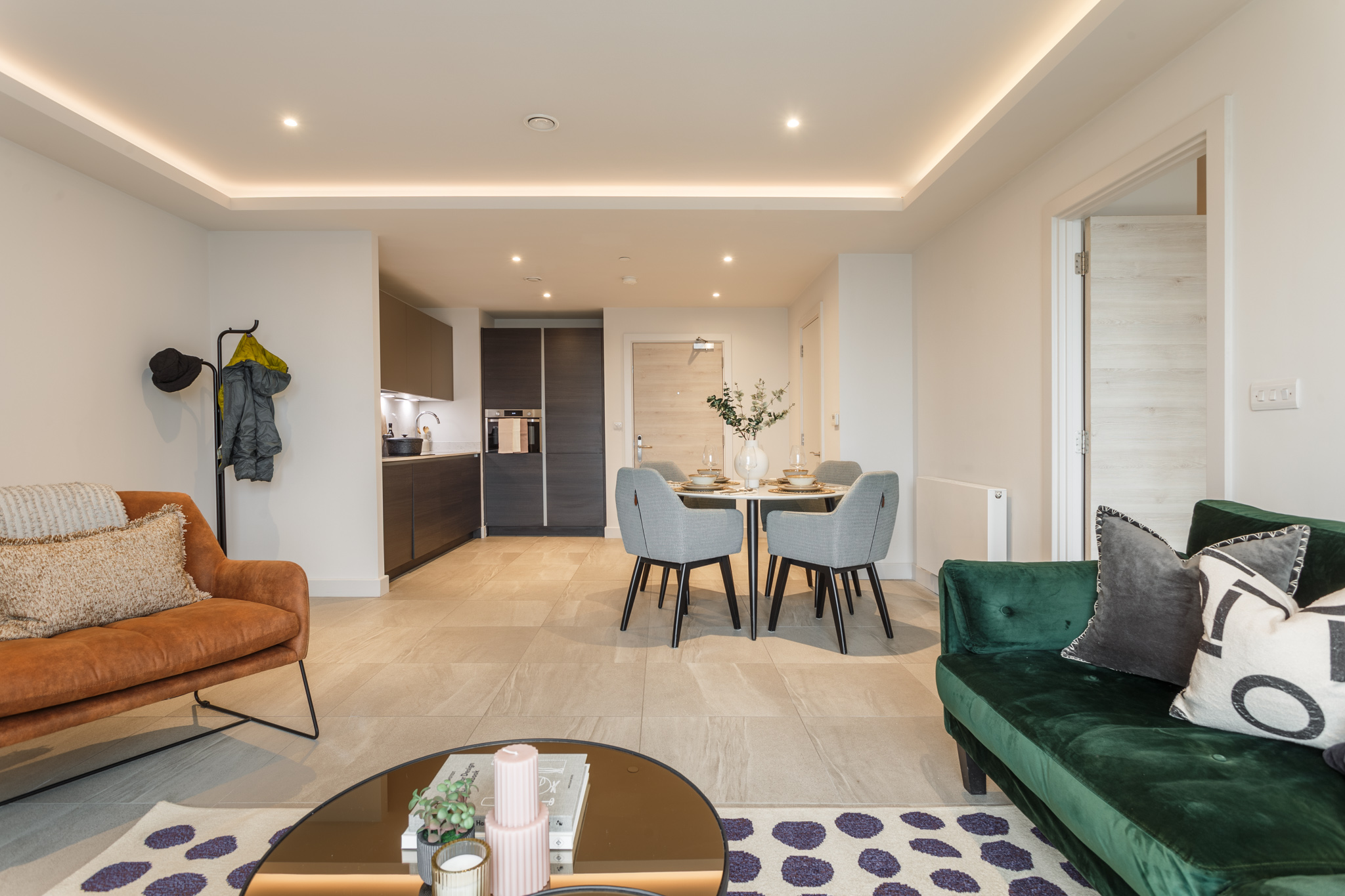 kitchen and lounge with breakfast and coffee table, windows to balcony